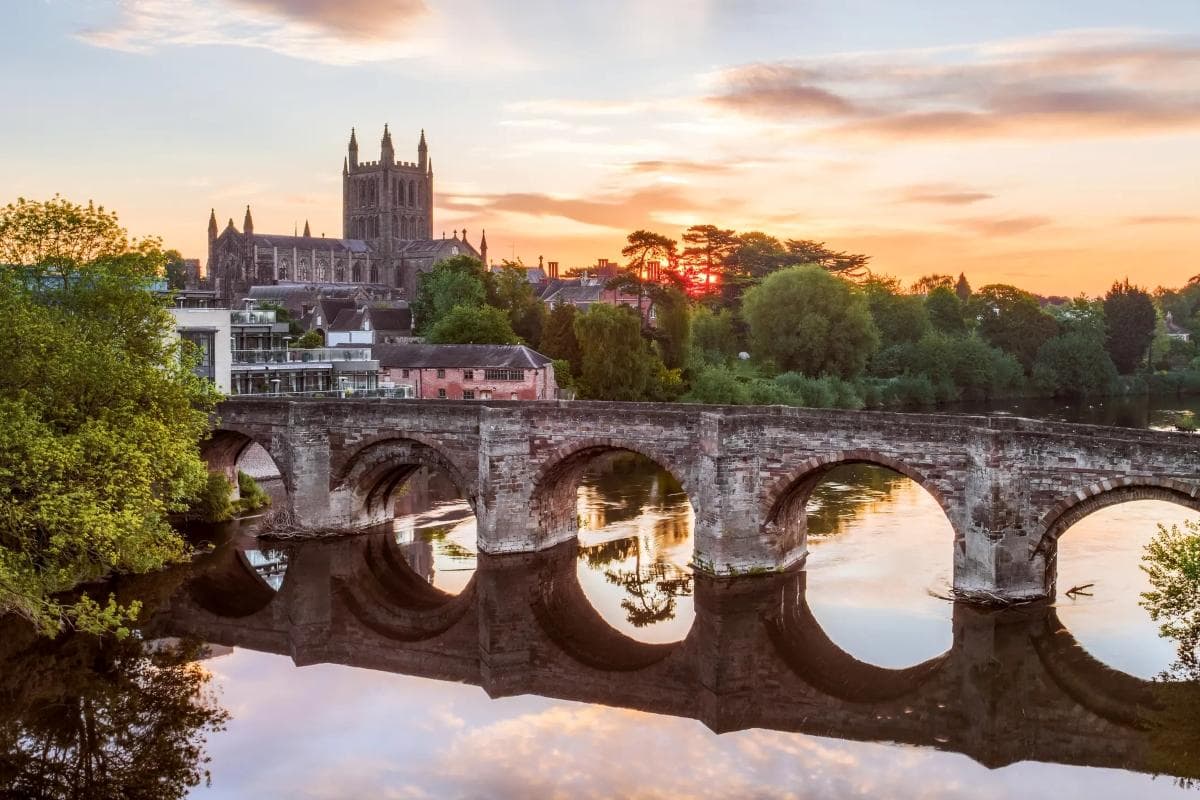 Old bridge and cathedral skyline at sunset